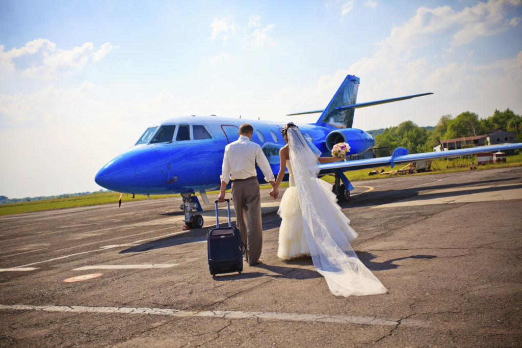 Wedding couple fly on honeymoon